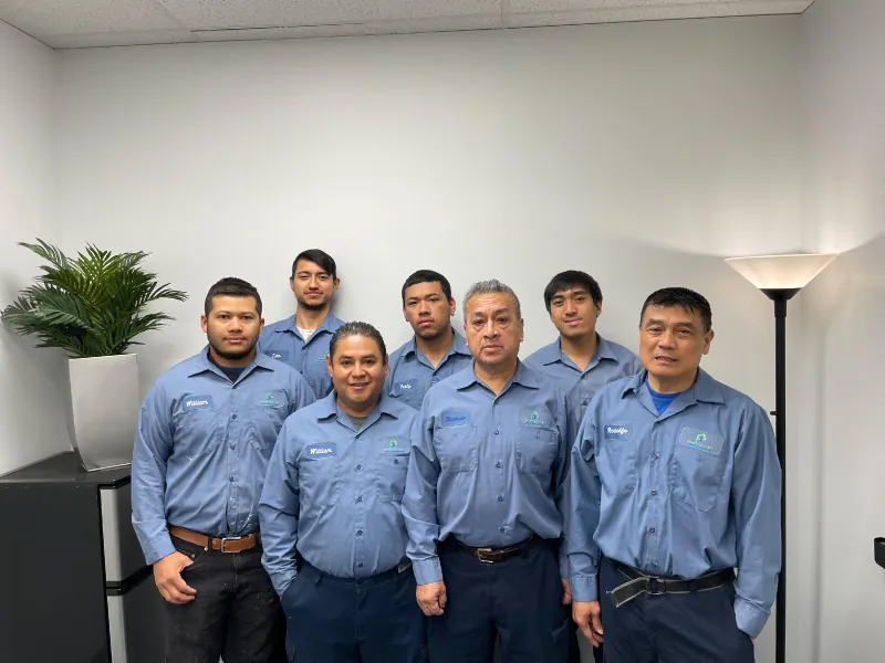 East Coast Mold Remediation team wearing company shirts in an office.